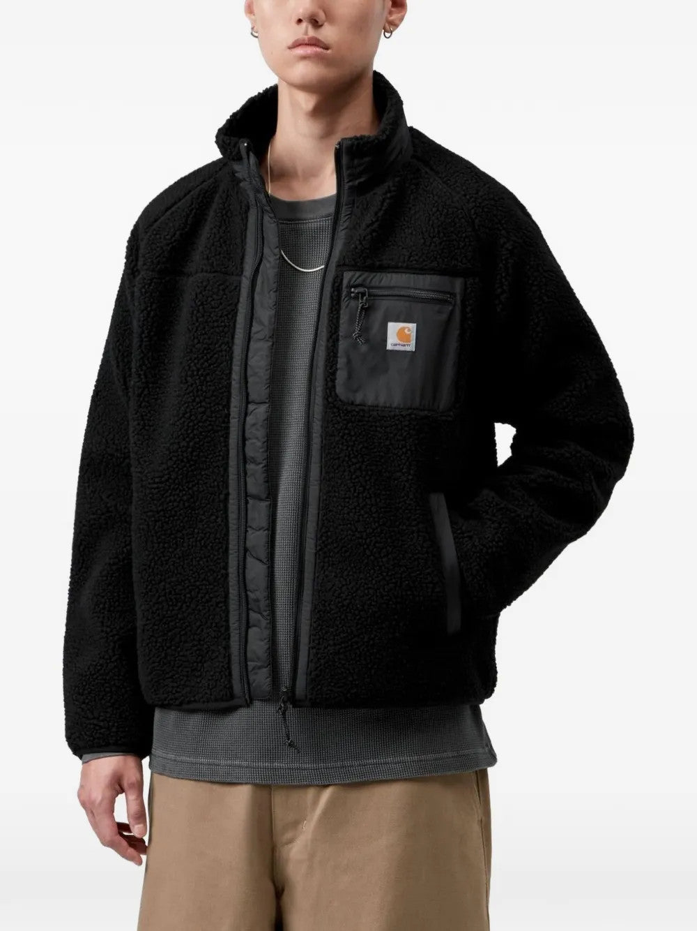 Black jacket worn by a person, showing the jacket fit
