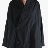 Black jacket worn by a person, showing the jacket fit