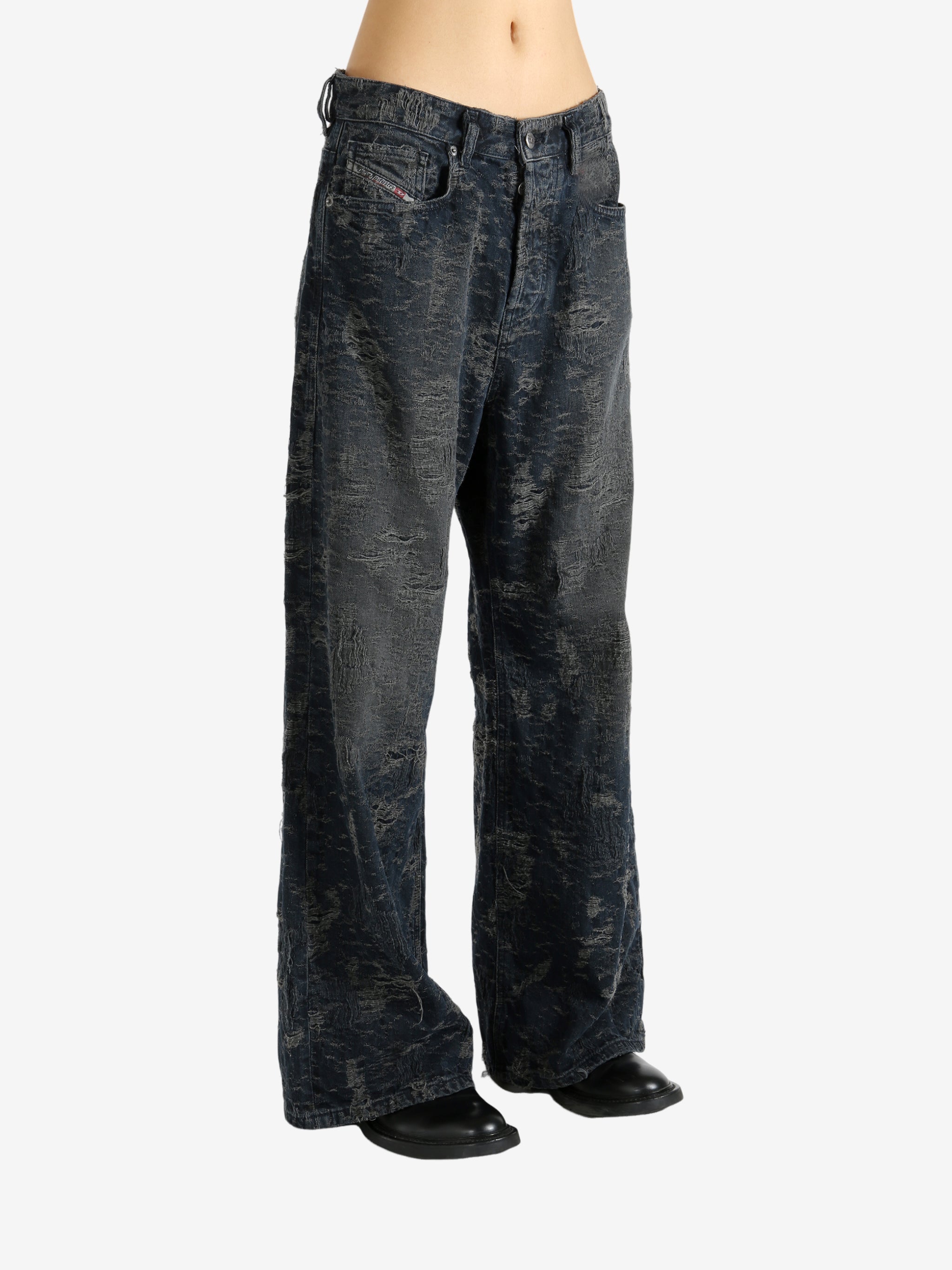 Black jeans worn by a person, showing the jeans' fit