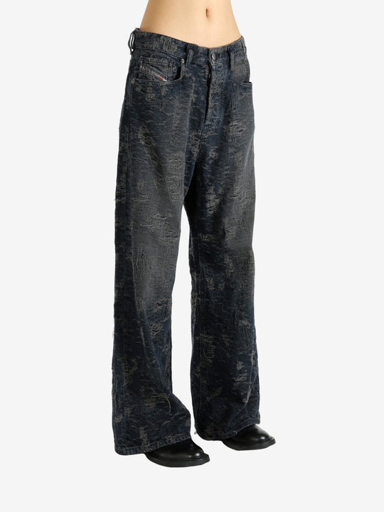 Black jeans worn by a person, showing the jeans' fit