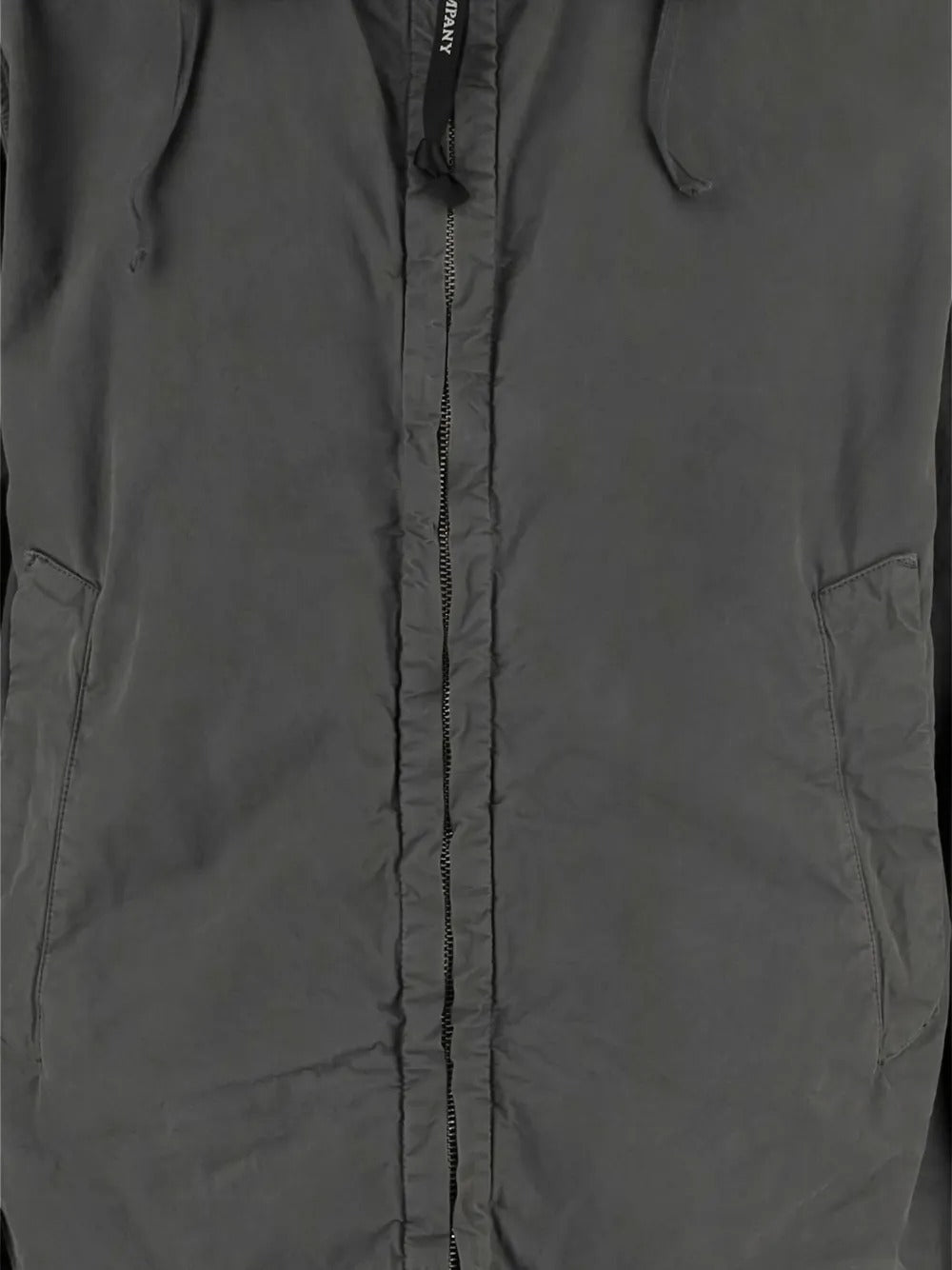 Close up of grey jackets, showing texture of the cotton fabric