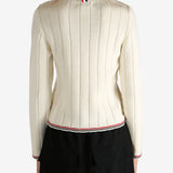 White knitwear worn by a person, showing the knitwear's fit