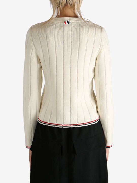 White knitwear worn by a person, showing the knitwear's fit