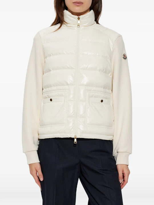White knitwear worn by a person, showing the knitwear fit
