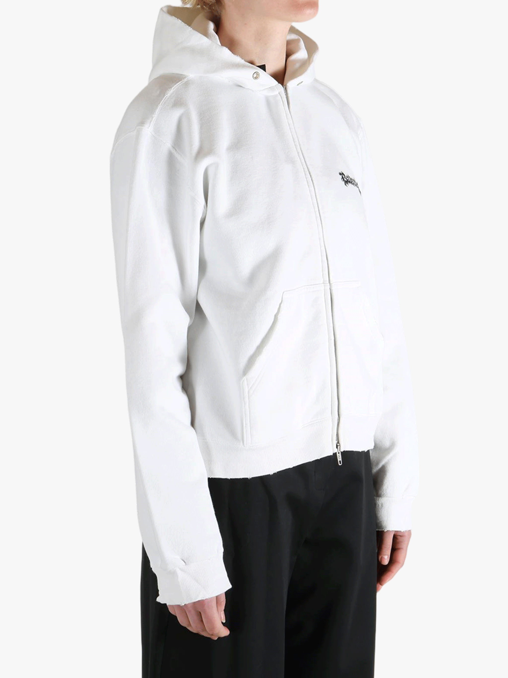 White hoodie worn by a person, showing the shirt's fit