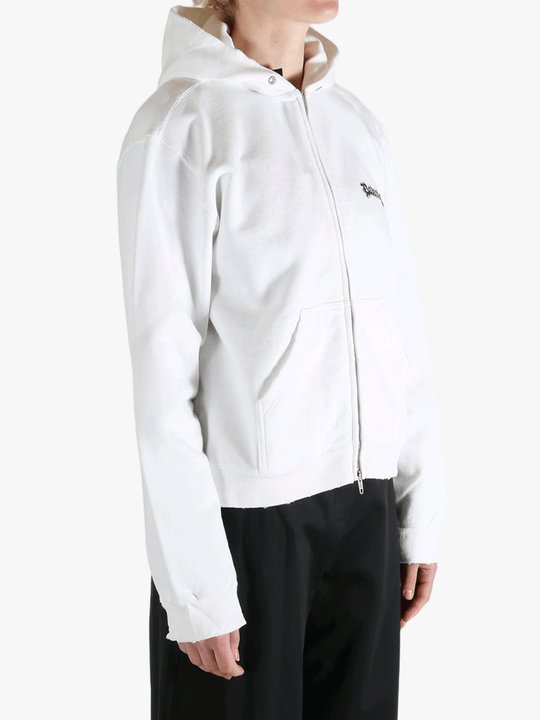 White hoodie worn by a person, showing the shirt's fit