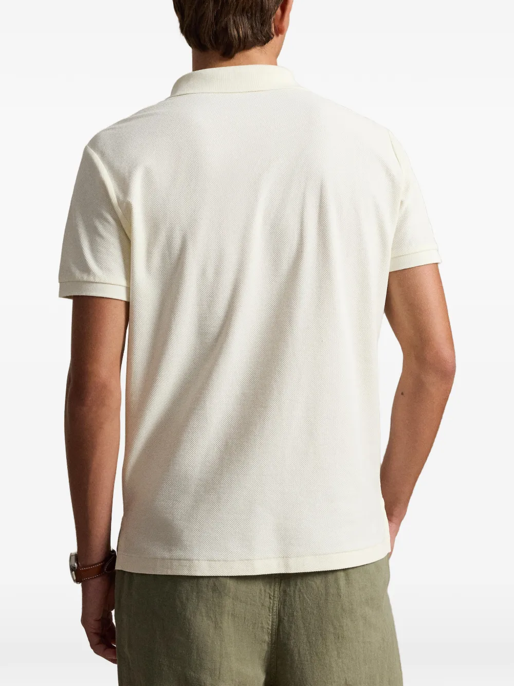 Tan shirt worn by a person, showing the shirt fit