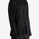 Black top worn by person, showing the top's fit