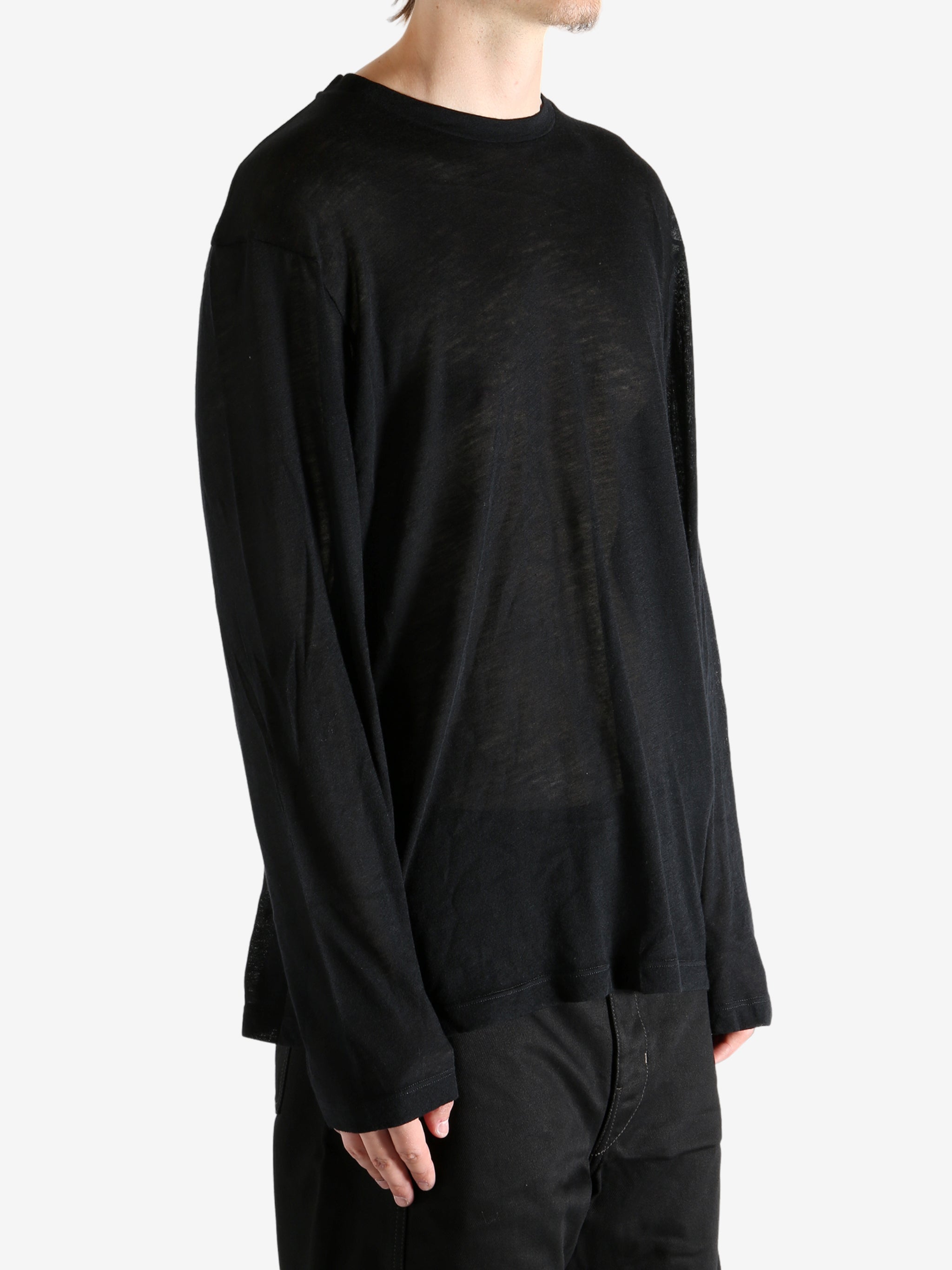 Black top worn by person, showing the top's fit