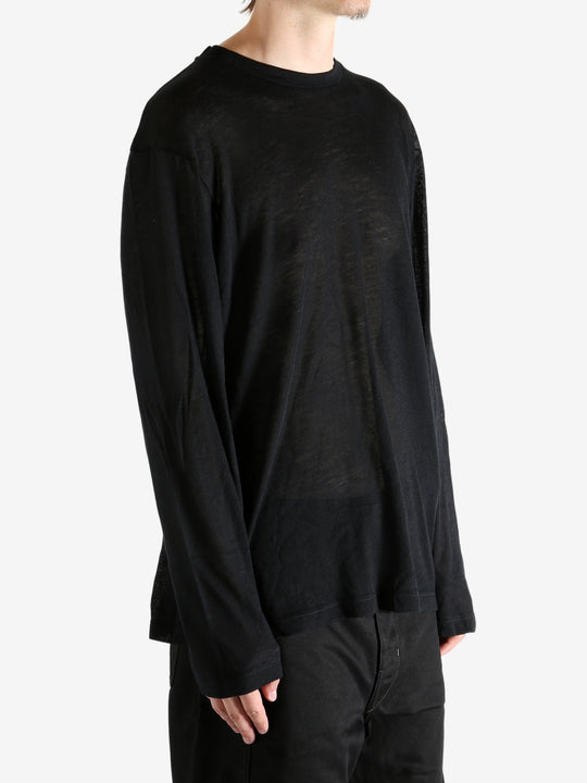 Black top worn by person, showing the top's fit