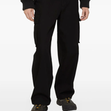 black pants worn by a person, showing the pants fit