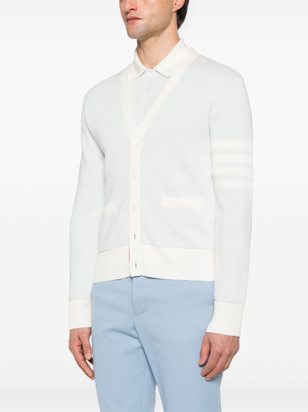 Blue knitwear worn by a person, showing the knitwear’s fit