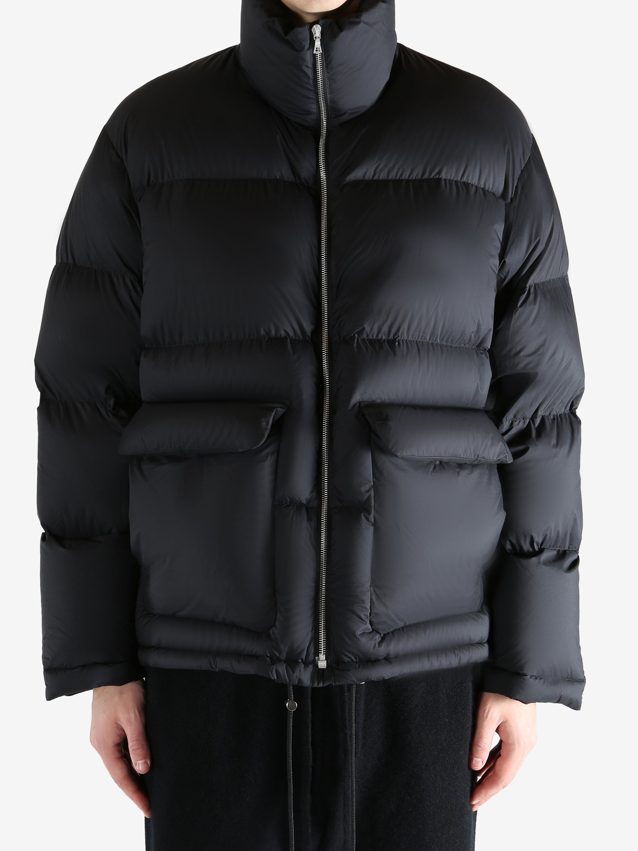 Black jacket worn by a person, showing the jacket's fit