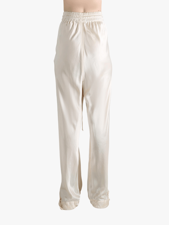 White pants worn by a person, showing the pant's fit