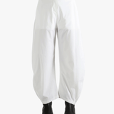 White pants worn by a person, showing the pants fit