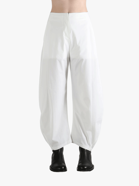 White pants worn by a person, showing the pants fit