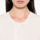 Unknown top worn by a person, showing the top fit