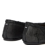 Close up of black flat , showing texture of the lamb skin fabric