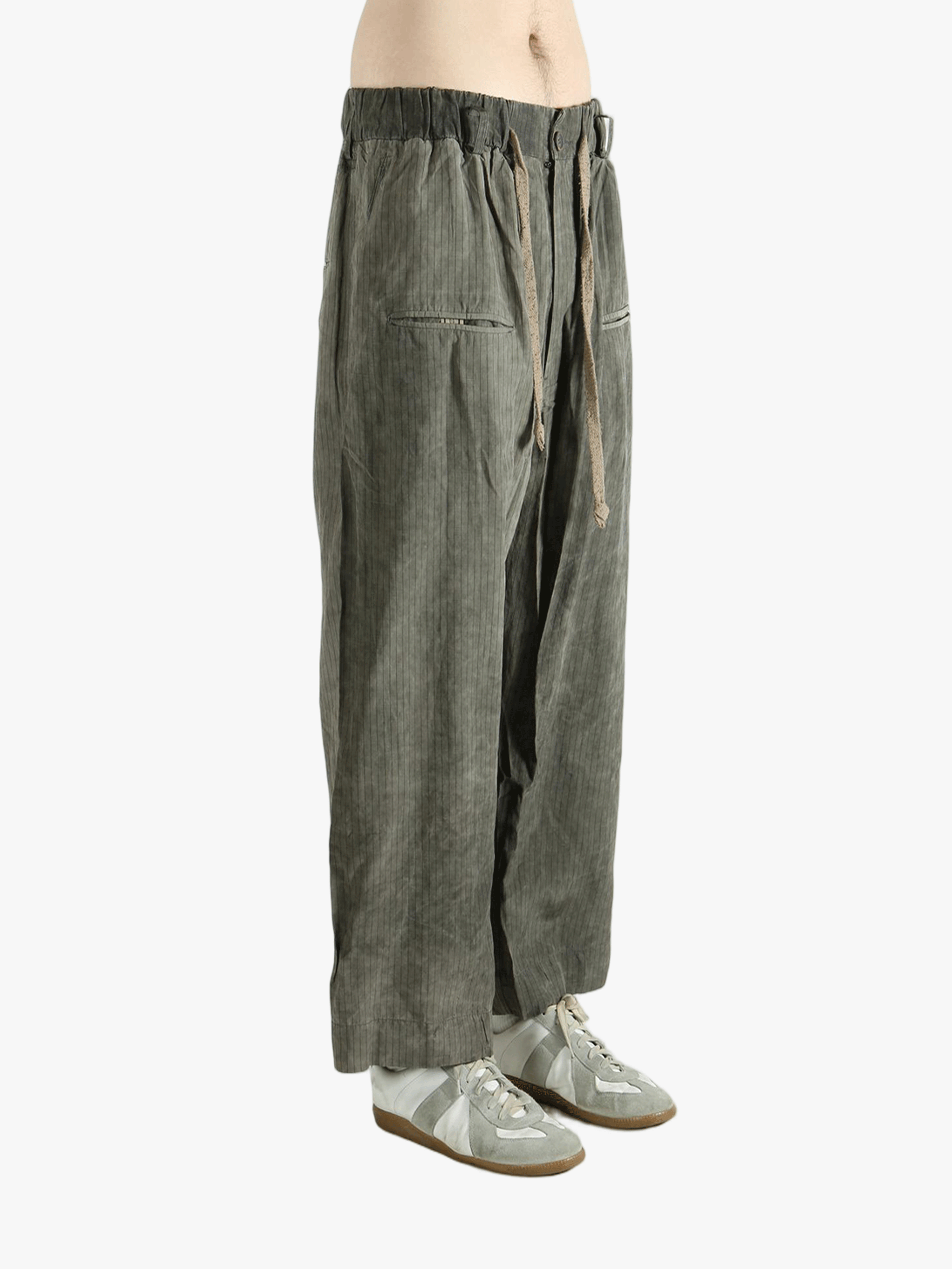 Green wide-leg pants worn by a person, showing the pants fit