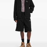 Black jacket worn by a person, showing the jacket's fit