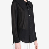 Black top worn by a person, showing the top fit