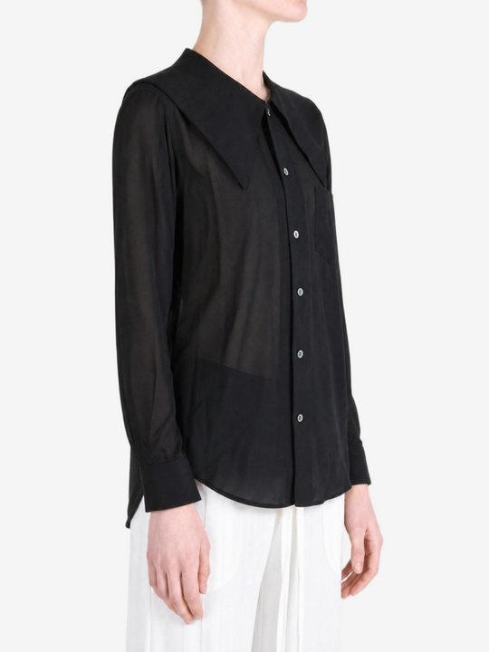 Black top worn by a person, showing the top fit