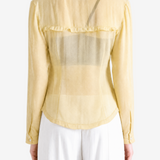 Tan shirt worn by a person, showing the shirt fit