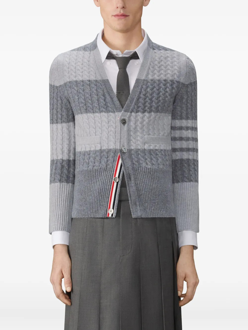 Grey knitwear worn by a person, showing the knitwear fit