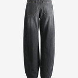 Black jeans worn by a person, showing the jean's fit