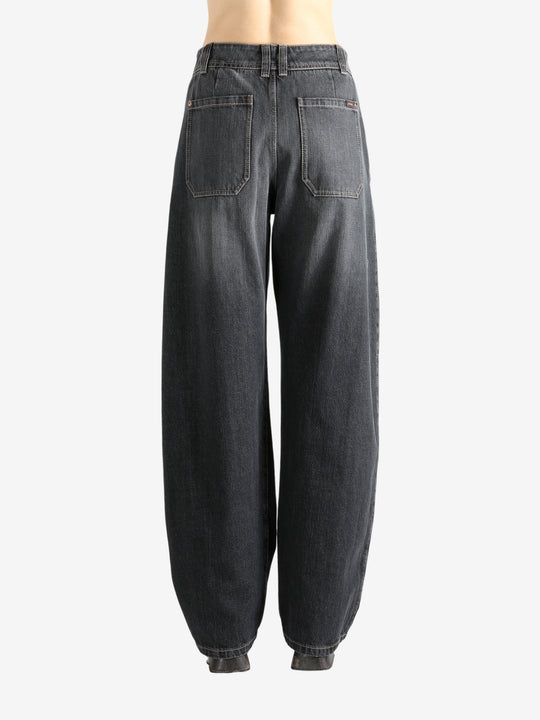 Black jeans worn by a person, showing the jean's fit