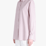 Pink shirt worn by a person, showing the shirt fit