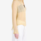 Tan shirt worn by a person, showing the shirt fit