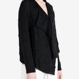 Black shirt worn by a person, showing the shirt fit