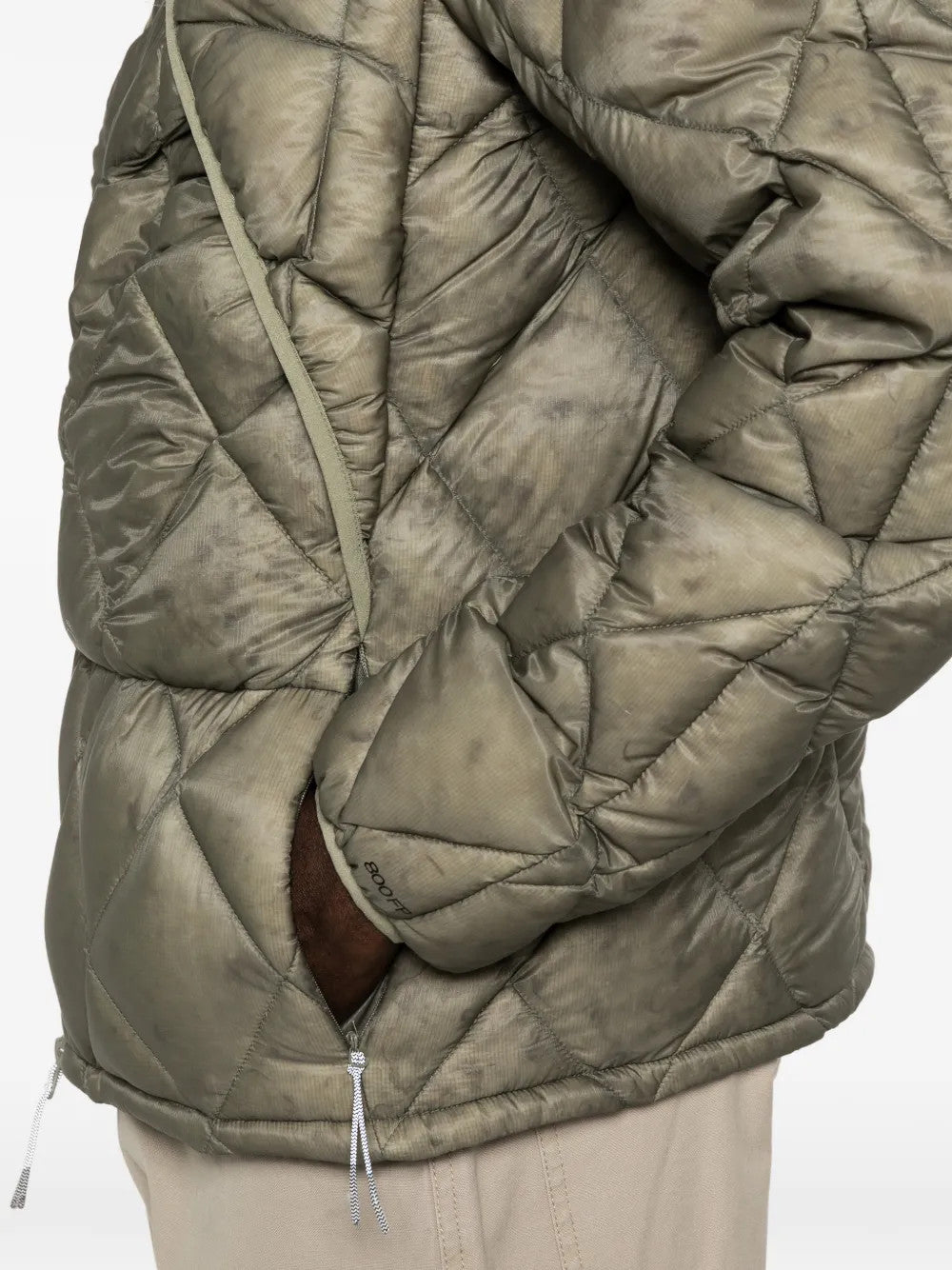 Green jacket worn by a person, showing the jacket fit