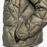 Green jacket worn by a person, showing the jacket fit