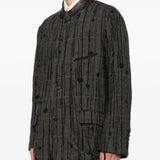 Grey blazer worn by a person, showing the blazer fit