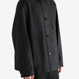 Black shirt worn by a person, showing the shirt's fit