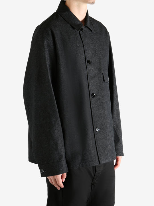 Black shirt worn by a person, showing the shirt's fit