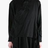Black shirt worn by a person, showing the shirt's fit