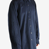Navy shirt worn by a person, showing the shirt's fit