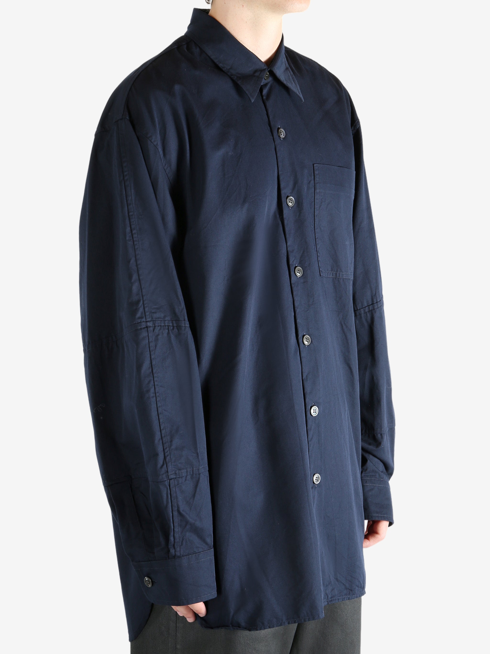 Navy shirt worn by a person, showing the shirt's fit