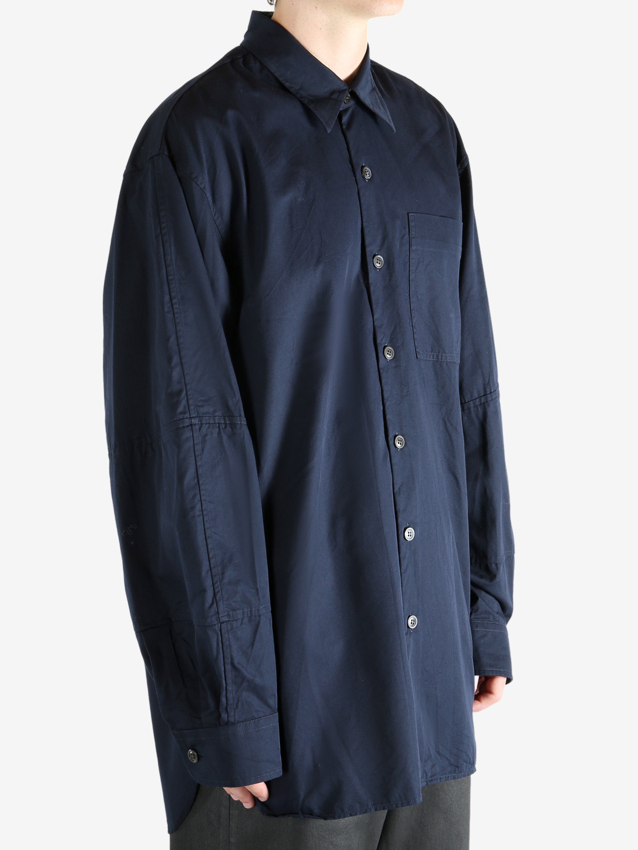 Navy shirt worn by a person, showing the shirt's fit