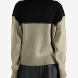 Black knitwear worn by a person, showing the knitwear fit