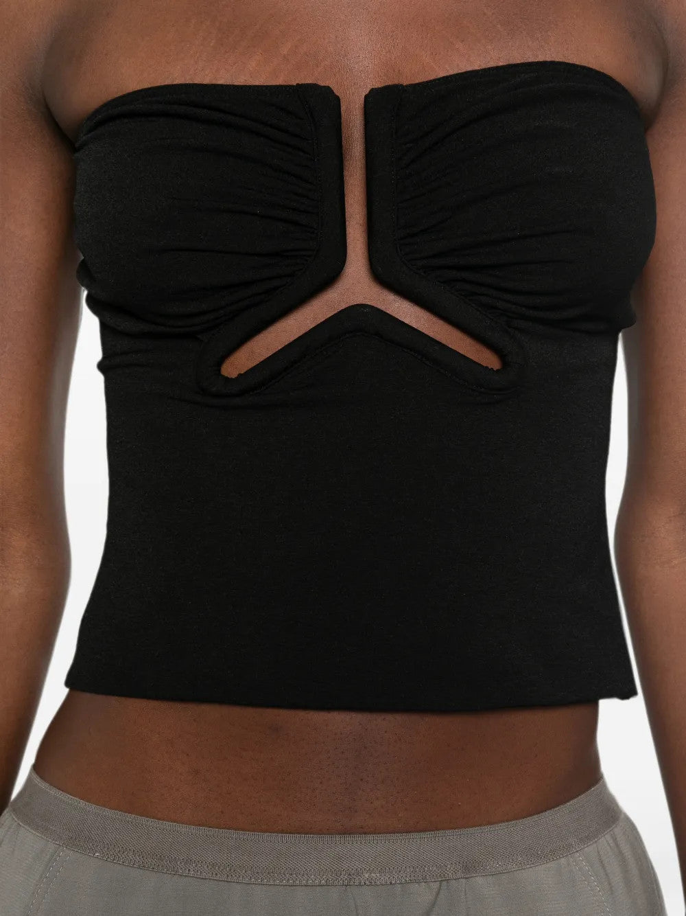 Black top worn by a person, showing the top fit