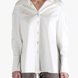 White shirt worn by a person, showing the shirt's fit