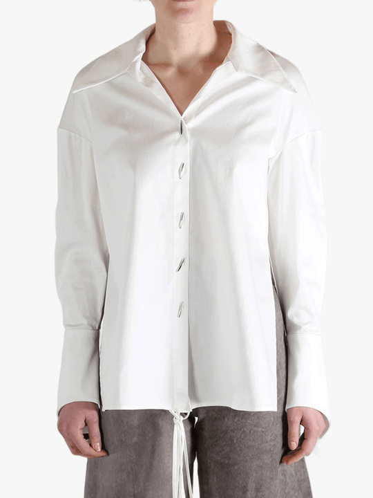 White shirt worn by a person, showing the shirt's fit