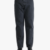Black jeans worn by a person, showing the jeans fit