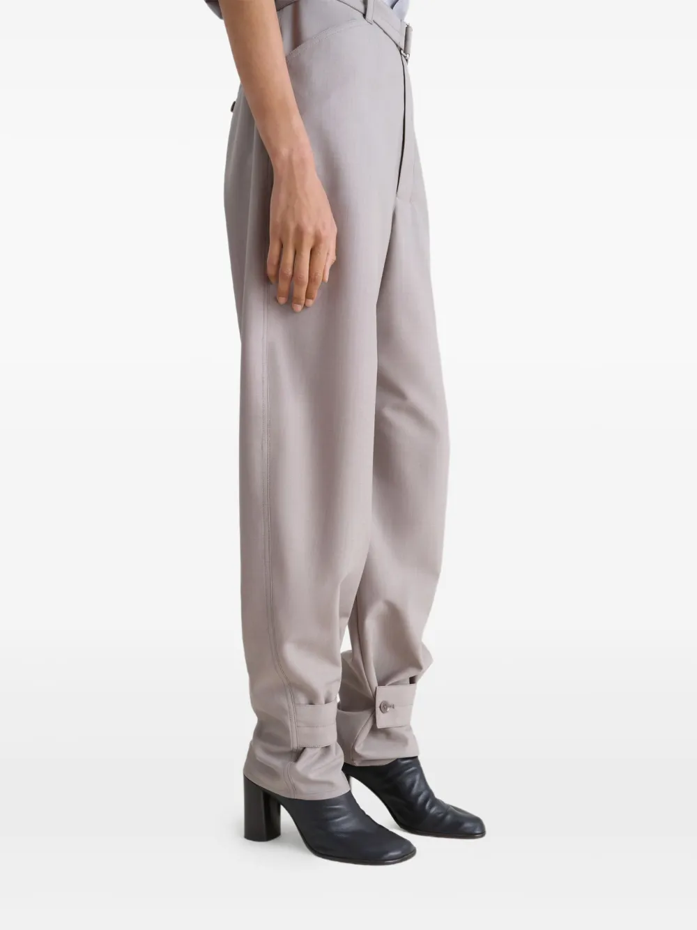 Black boots worn by a person, showing the boots' fit