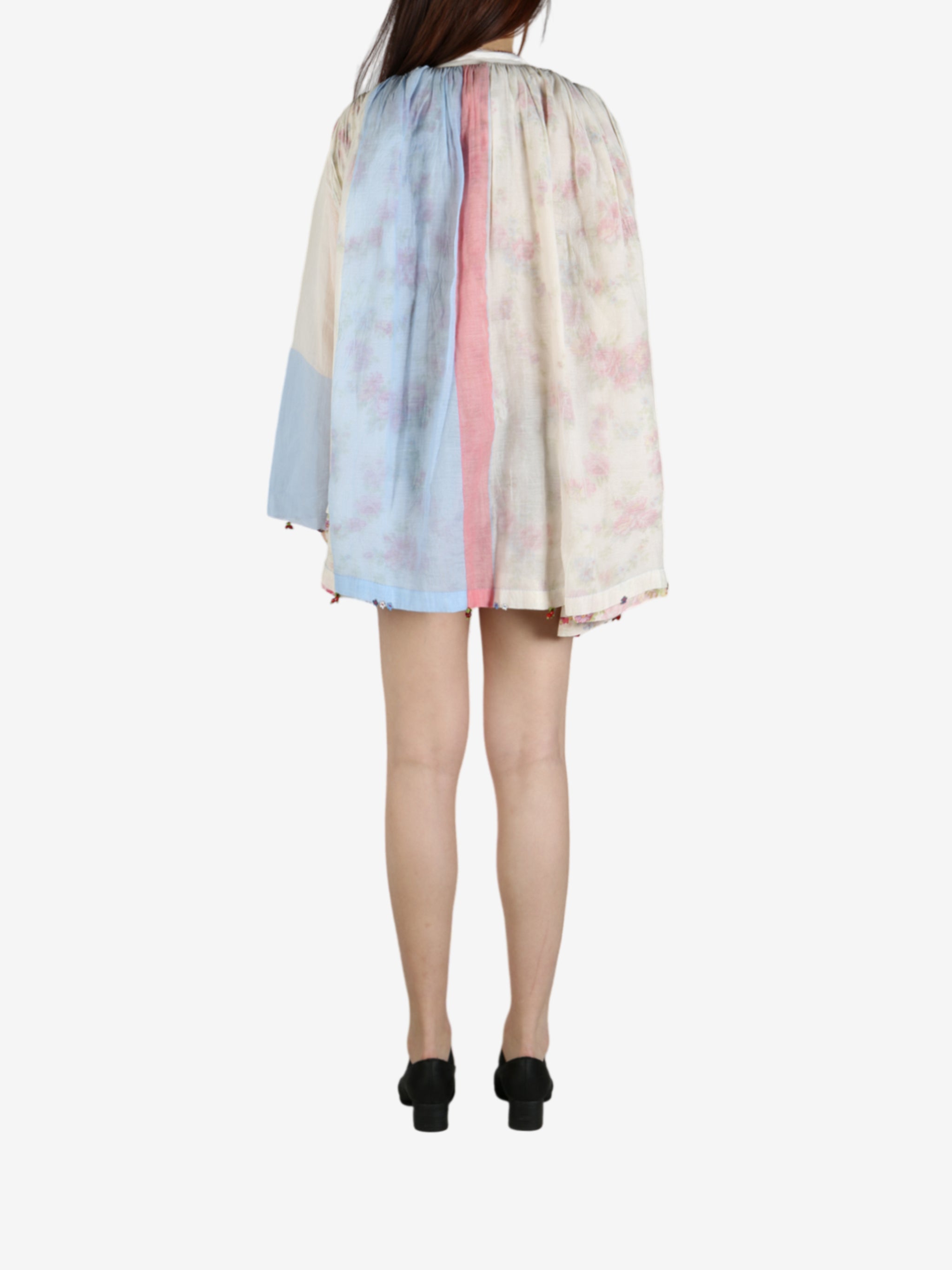 Tan shirt worn by a person, showing the shirt’s fit