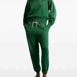 Green sweatshirt worn by a person, showing the sweatshirt‘s fit